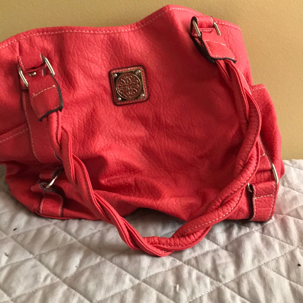 Nice and roomy purse an off-color with twisted handles